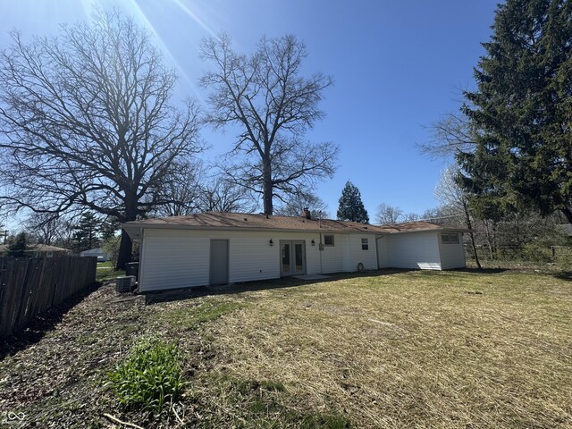 7406 E 33rd St, Indianapolis, IN 46226 - rear view of house with central air condition unit, a yard, fence, french doors, and a chimney