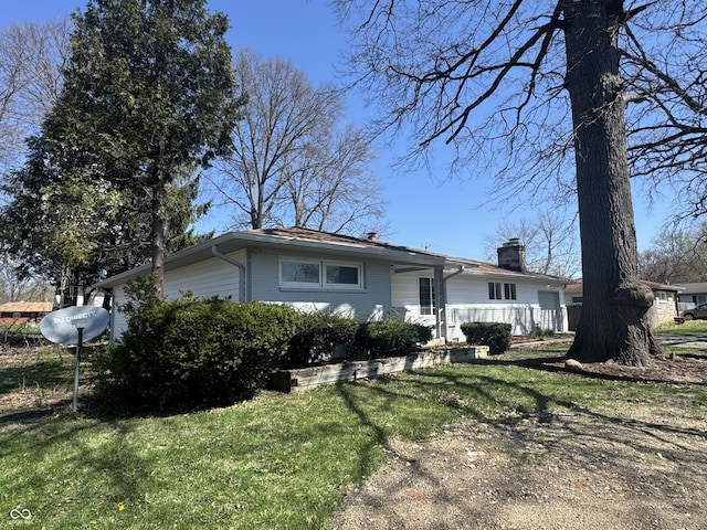 7406 E 33rd St, Indianapolis, IN 46226 - view of front facade with a chimney and a front lawn