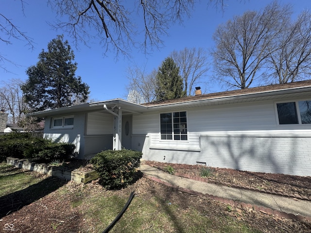 7406 E 33rd St, Indianapolis, IN 46226 - view of front facade with a chimney and brick siding