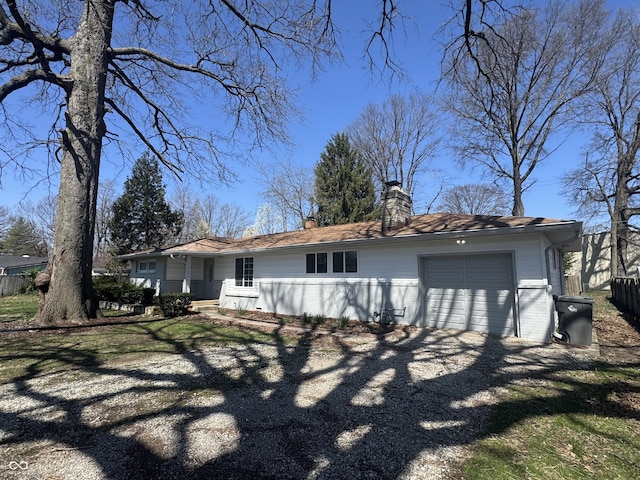 7406 E 33rd St, Indianapolis, IN 46226 - rear view of property featuring an attached garage, a chimney, and fence
