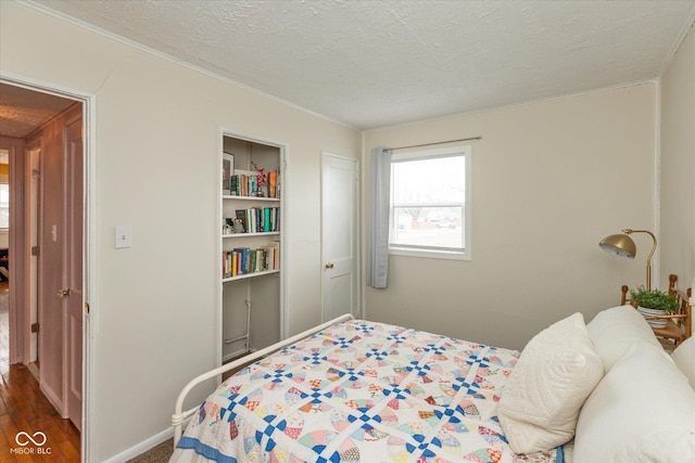 bedroom featuring baseboards and a textured ceiling