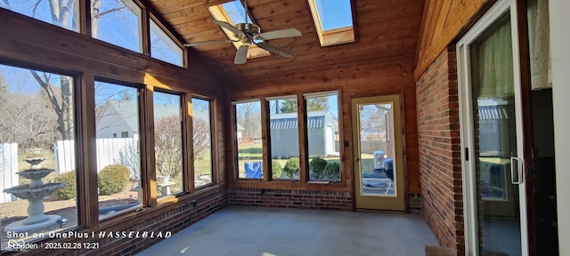 unfurnished sunroom featuring lofted ceiling with skylight, wood ceiling, and a ceiling fan