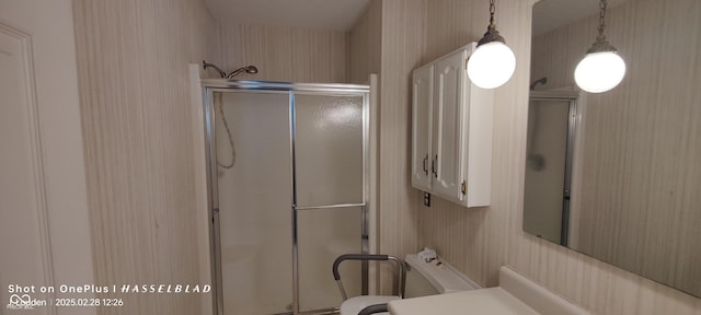 full bathroom with a shower stall and toilet