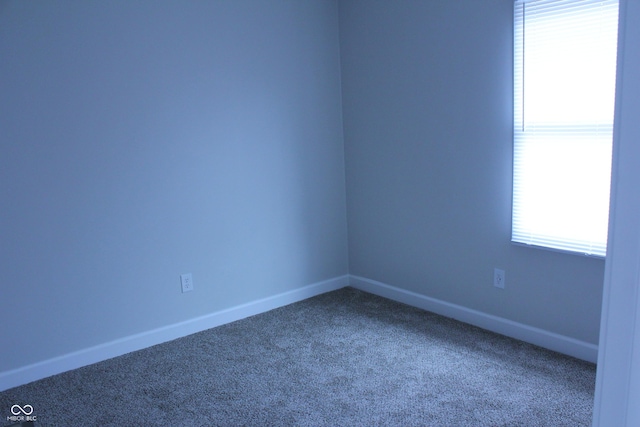 spare room with carpet and baseboards