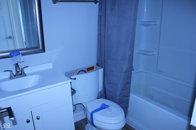 bathroom featuring toilet, shower / tub combo, and vanity