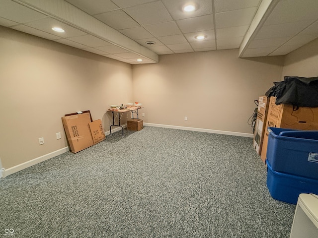 finished basement featuring carpet floors, baseboards, a drop ceiling, and recessed lighting