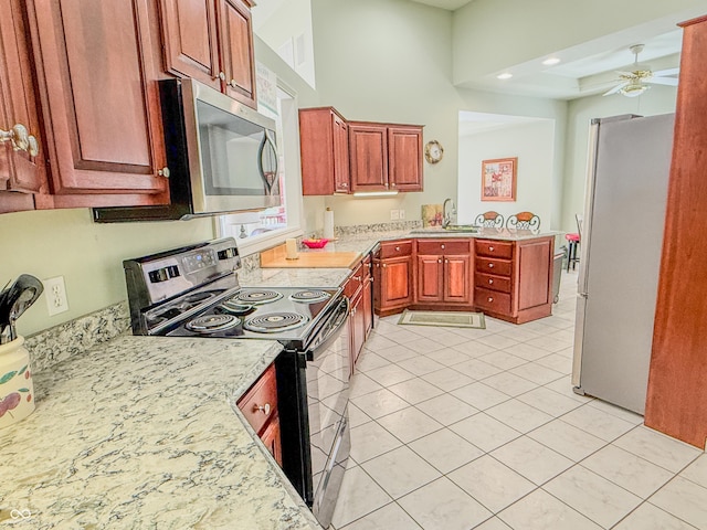 kitchen with light tile patterned floors, ceiling fan, stainless steel appliances, a sink, and recessed lighting