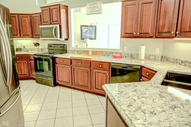 kitchen with light stone countertops, black appliances, light tile patterned floors, and visible vents