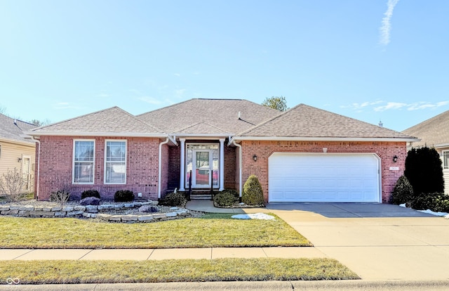 ranch-style home featuring a garage, brick siding, driveway, and a shingled roof