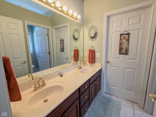 full bath featuring a sink, toilet, and double vanity