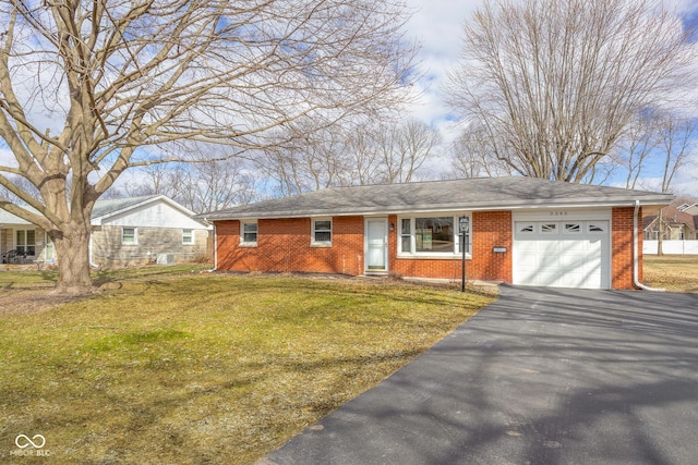 ranch-style house featuring a garage, a front lawn, aphalt driveway, and brick siding