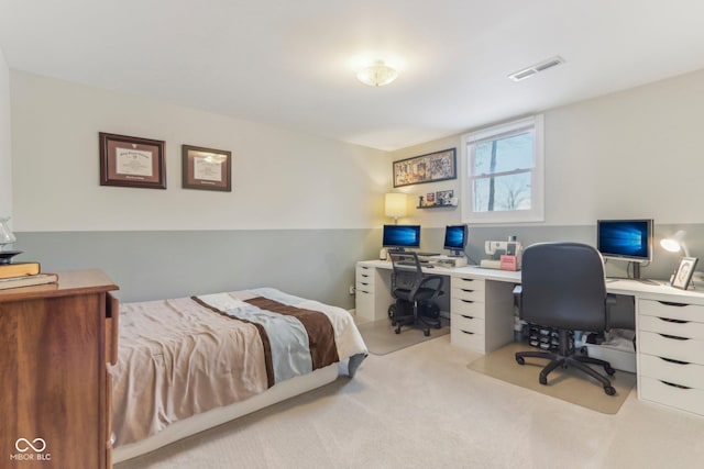 carpeted bedroom featuring visible vents