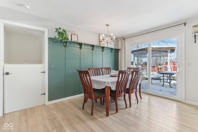 dining room featuring a notable chandelier and light wood finished floors