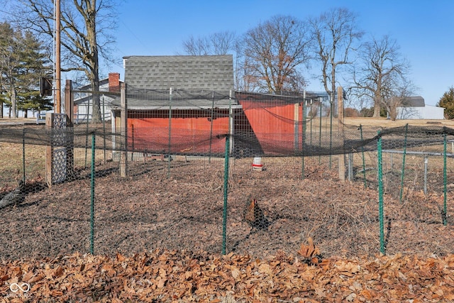 view of yard featuring exterior structure, an outdoor structure, and fence