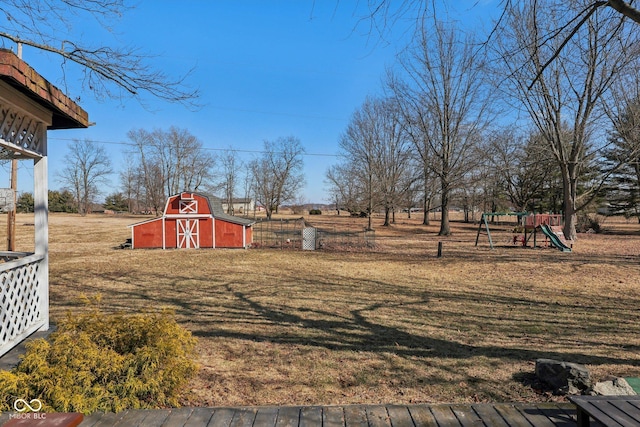 view of yard featuring an outbuilding, a barn, and a playground