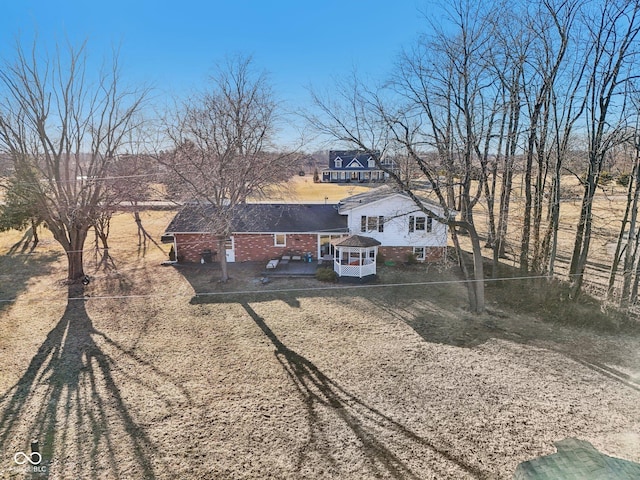 view of front facade featuring brick siding and driveway