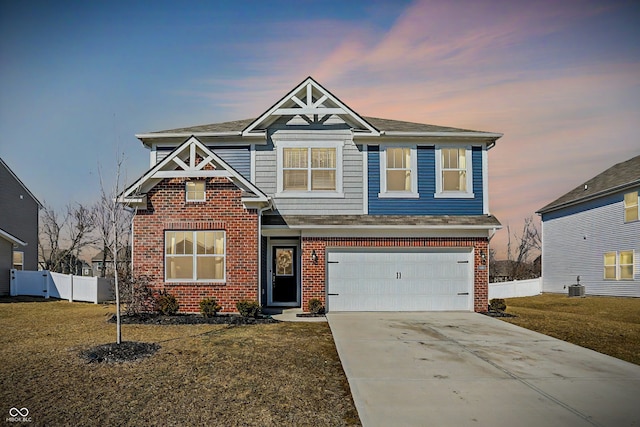 craftsman-style home with a garage, concrete driveway, brick siding, and fence