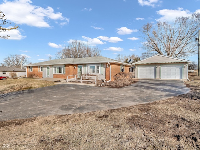 ranch-style house with a garage, brick siding, and an outbuilding