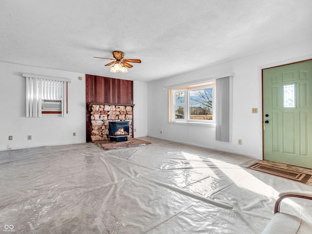 unfurnished living room with a ceiling fan and a textured ceiling