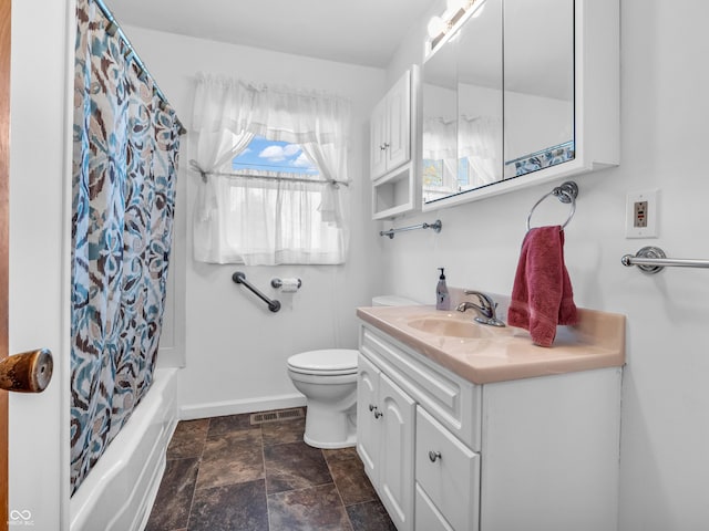 bathroom featuring visible vents, toilet, stone finish floor, vanity, and baseboards