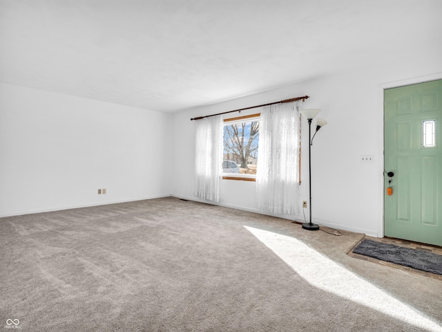 interior space featuring carpet flooring and baseboards