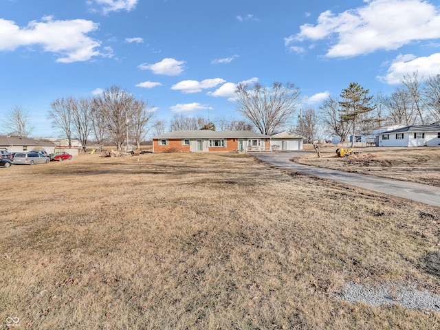 view of front of house with a garage and a front lawn