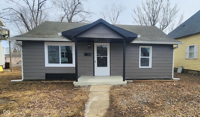 bungalow with roof with shingles and central AC