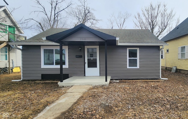 bungalow-style house with roof with shingles