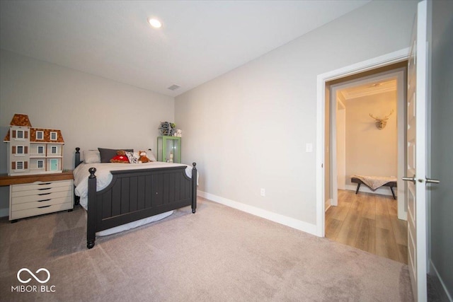 carpeted bedroom featuring recessed lighting and baseboards