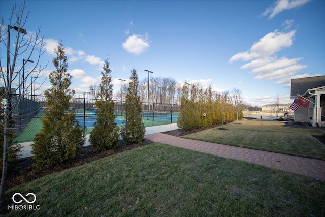 view of yard featuring a tennis court and fence