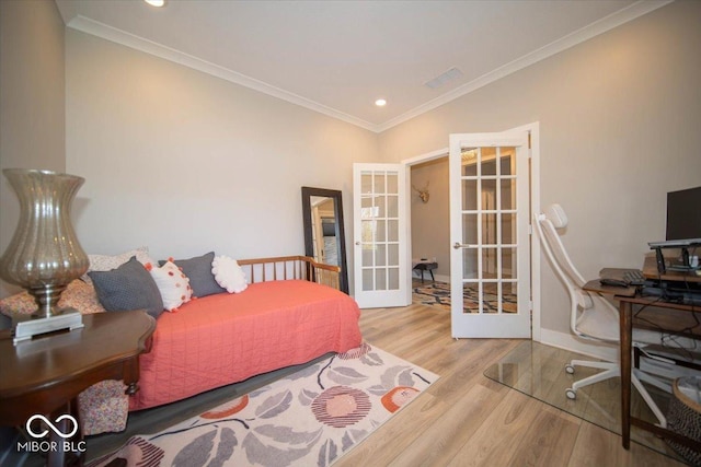 bedroom featuring baseboards, ornamental molding, wood finished floors, french doors, and recessed lighting