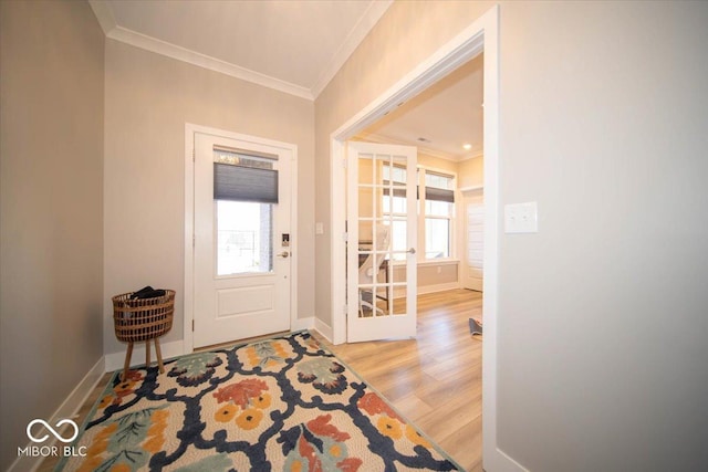 foyer entrance featuring french doors, ornamental molding, wood finished floors, and baseboards