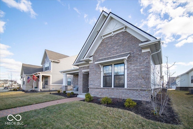 view of front of property with a front lawn and brick siding