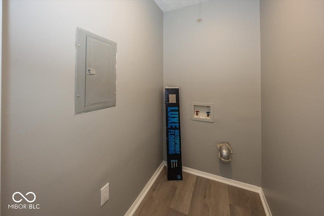 laundry room with baseboards, electric panel, laundry area, hookup for a washing machine, and wood finished floors