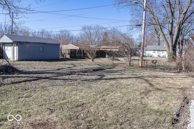 view of yard featuring an outbuilding and fence