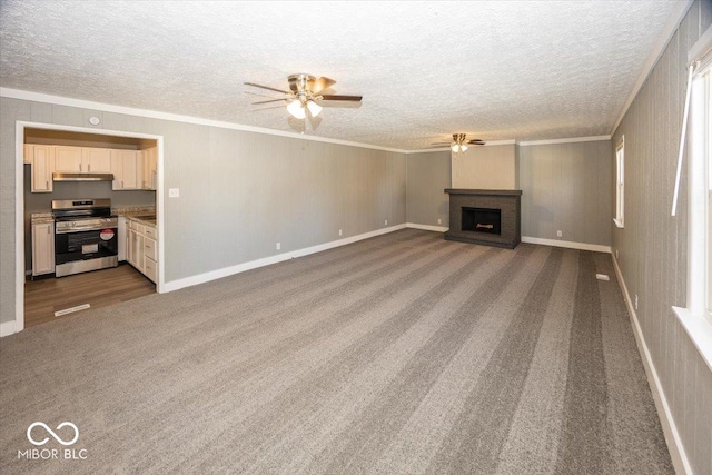 unfurnished living room featuring a fireplace, a textured ceiling, crown molding, and ceiling fan