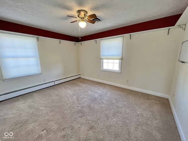 empty room with a ceiling fan, light colored carpet, a textured ceiling, and baseboard heating