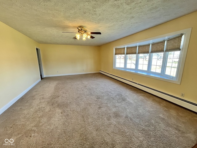 carpeted empty room featuring a baseboard radiator, ceiling fan, a textured ceiling, and baseboards