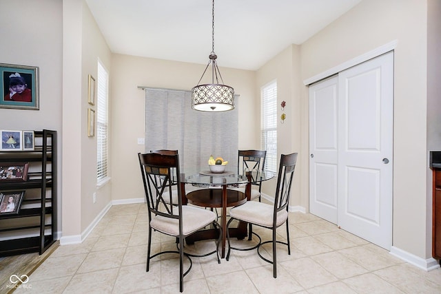 dining space with light tile patterned flooring and baseboards