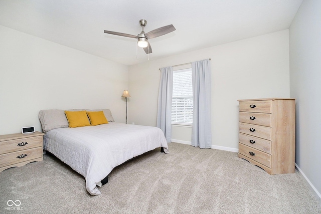 bedroom featuring light carpet, ceiling fan, and baseboards