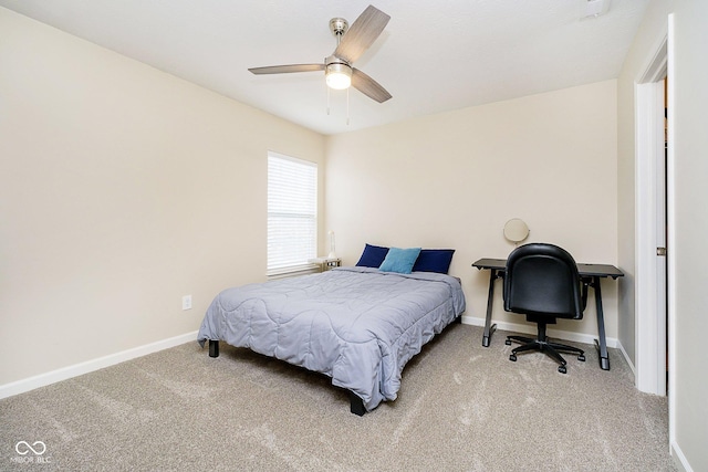 bedroom with light carpet, ceiling fan, and baseboards