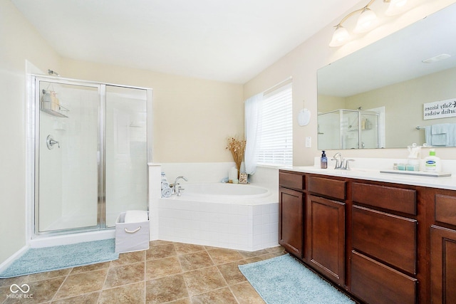 bathroom featuring a stall shower, tile patterned flooring, a garden tub, and vanity