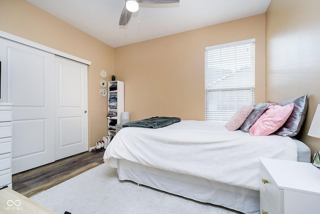 bedroom featuring ceiling fan, a closet, and wood finished floors