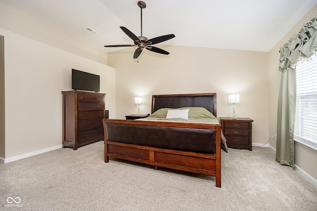 bedroom with light carpet, ceiling fan, baseboards, and lofted ceiling