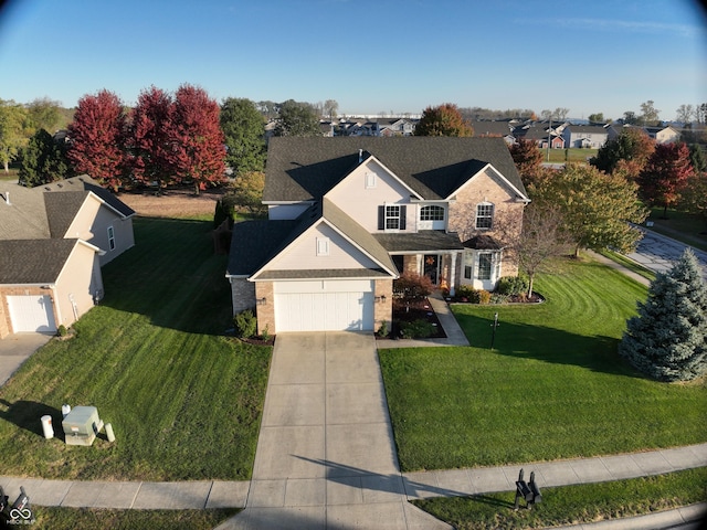 traditional-style house with a front yard and concrete driveway