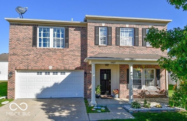 view of front facade featuring an attached garage, brick siding, and driveway