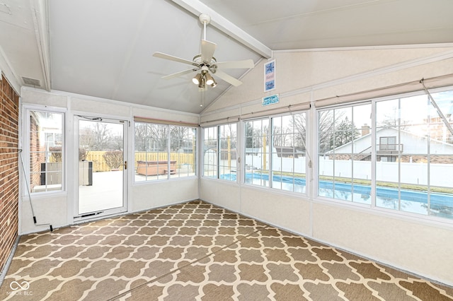 unfurnished sunroom featuring a ceiling fan and vaulted ceiling with beams