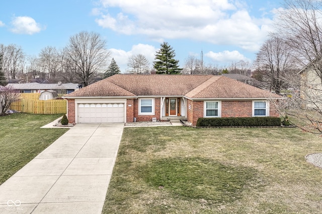 ranch-style home with an attached garage, brick siding, fence, concrete driveway, and a front lawn