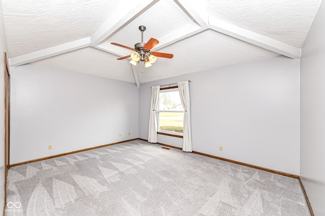 unfurnished room featuring carpet flooring, lofted ceiling with beams, and a textured ceiling