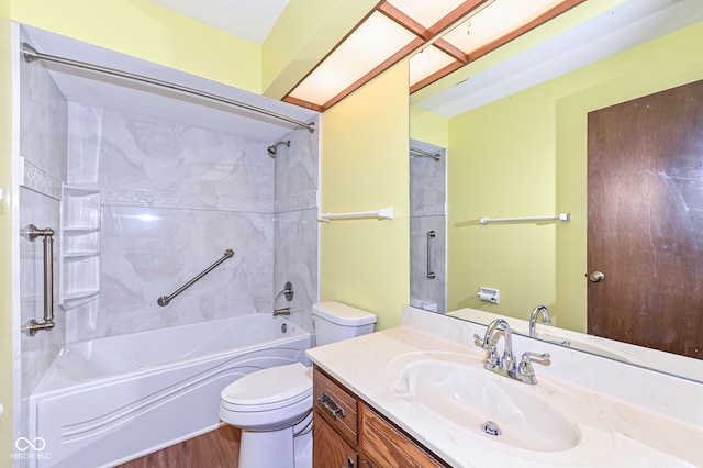 full bath with washtub / shower combination, wood finished floors, vanity, and toilet